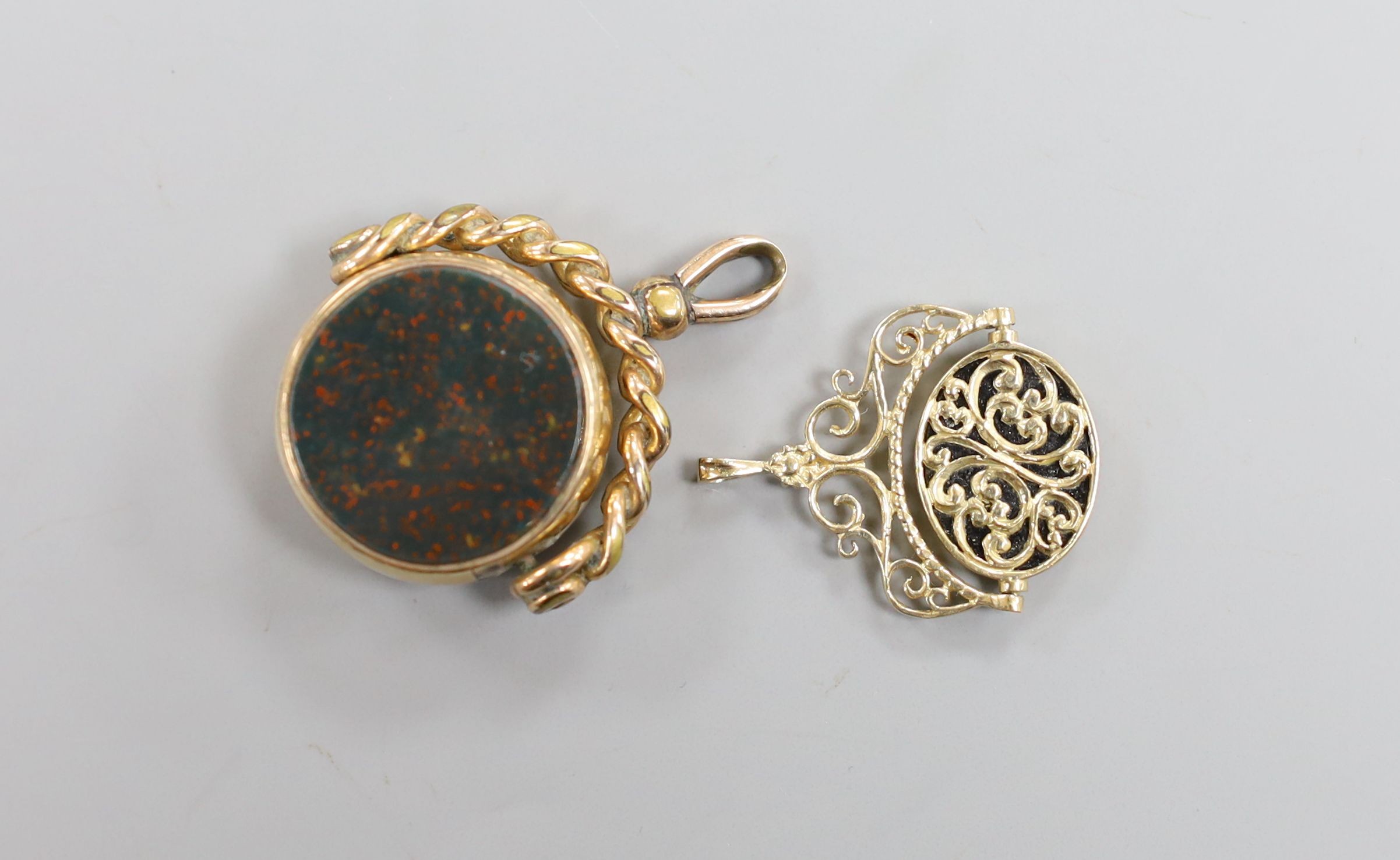 A Victorian gold, bloodstone and carnelian set spinning fob, 37mm and a later yellow metal and chalcedony set spinning fob.